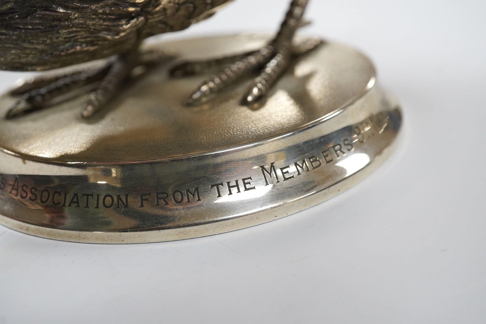 An Elizabeth II silver presentation cockerel, on a circular base with engraved inscription, by Garrard & Co Ltd, London, 1953, overall height 14cm, weighted. Condition - fair to good